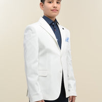 A boy wearing a white suit with a blue shirt and a blue tie.