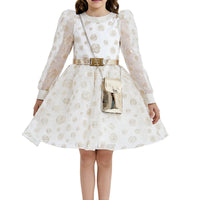 A girl wearing an ivory and gold long-sleeved dress with a full gathered skirt, standing against a white background.