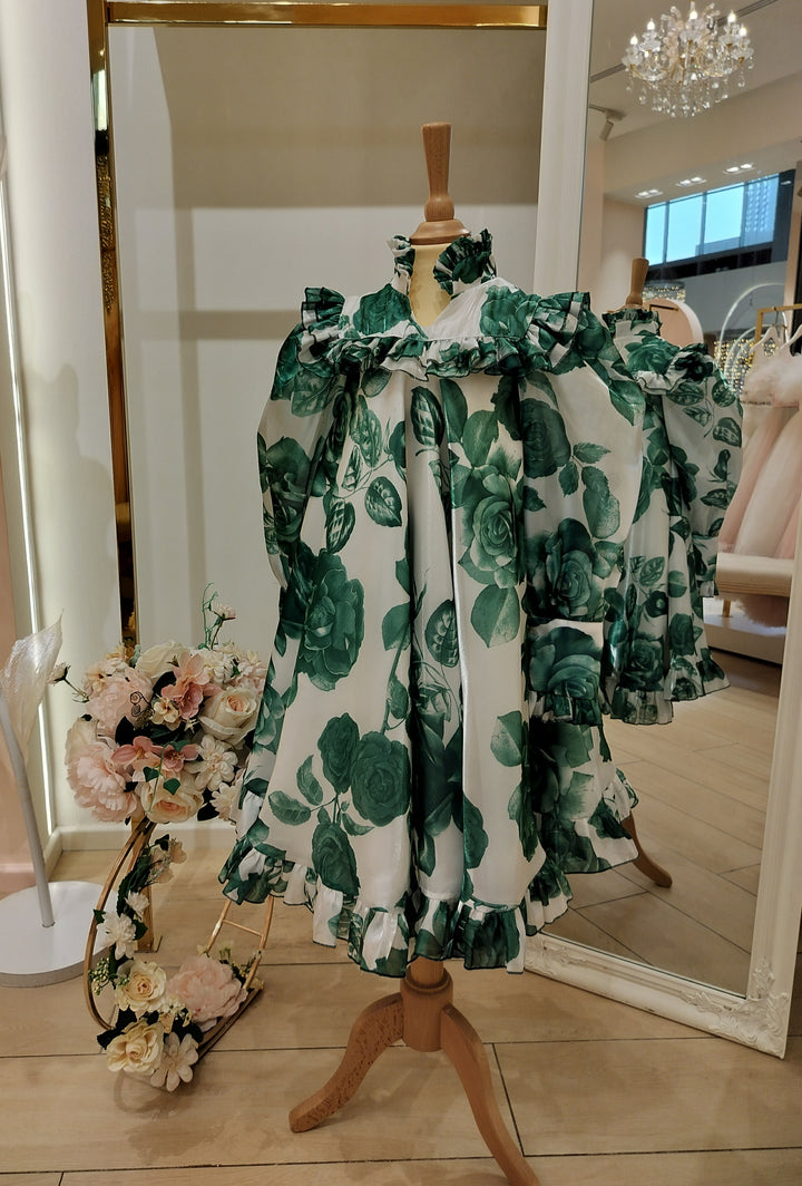 A green floral occasion dress for girls displayed on a mannequin.